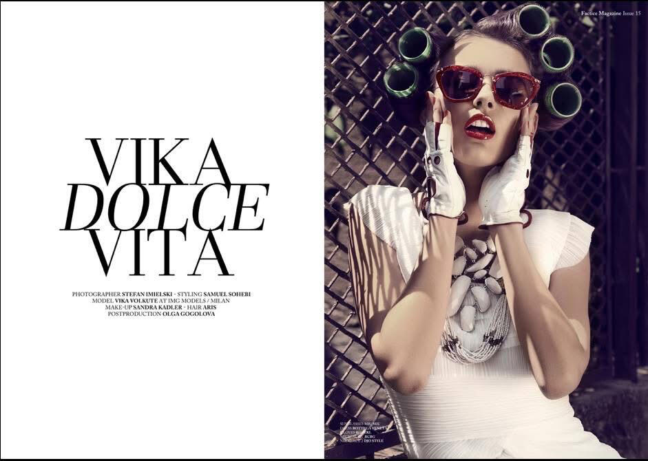 Fashion editorial opening page titled “Vika Dolce Vita” published in Factice Magazine. Model Vika Volkute wears a sculptural white dress, statement necklace, white leather gloves and red cat-eye sunglasses with oversized hair rollers. Editorial styling by