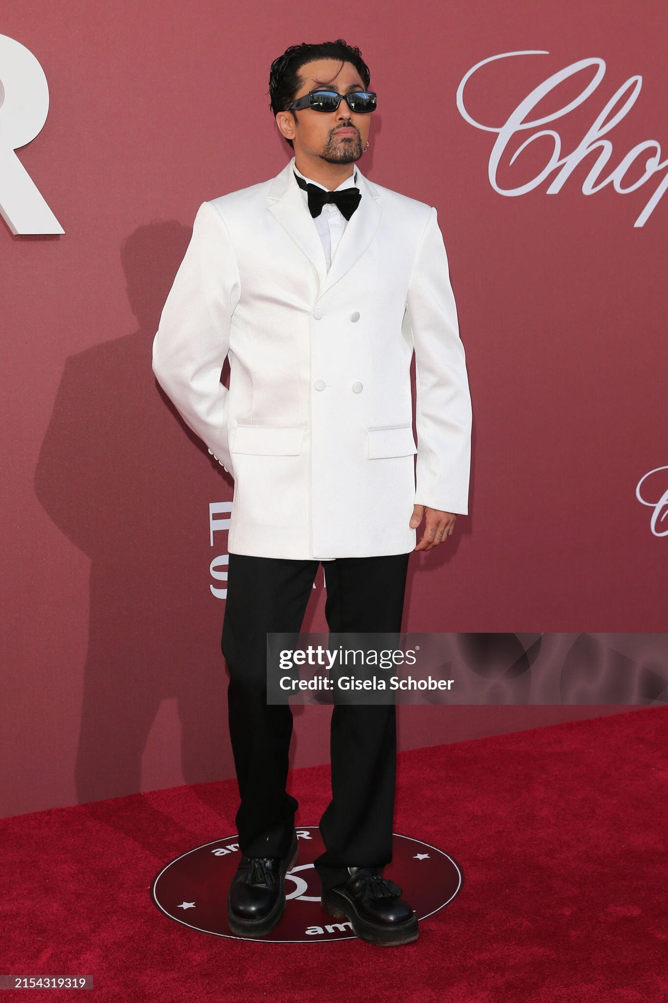 Samuel Sohebi at the amfAR Gala during the Cannes Film Festival at Hotel du Cap-Eden-Roc, photographed during the evening recept Samuel Sohebi wearing a white custom tuxedo jacket by Gülafer Atlas at the amfAR Gala Cannes at Hotel du Cap-Eden-Roc during the evening reception