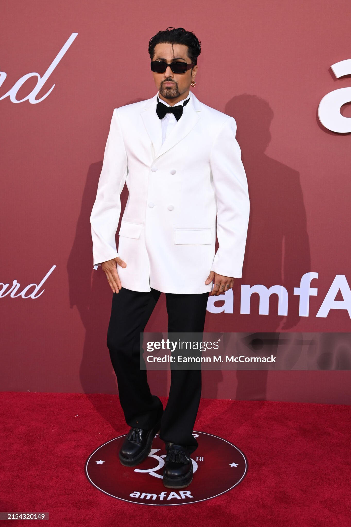 Samuel Sohebi at the amfAR Gala during the Cannes Film Festival at Hotel du Cap-Eden-Roc, photographed during the evening recept Samuel Sohebi wearing a white custom tuxedo jacket by Gülafer Atlas at the amfAR Gala Cannes at Hotel du Cap-Eden-Roc during the evening reception